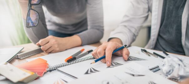 Graphic designer drawing sketches logo design.